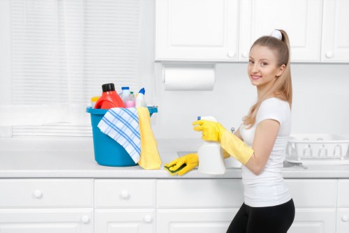 Office cleaning staff disinfecting high-touch surfaces in a business setting